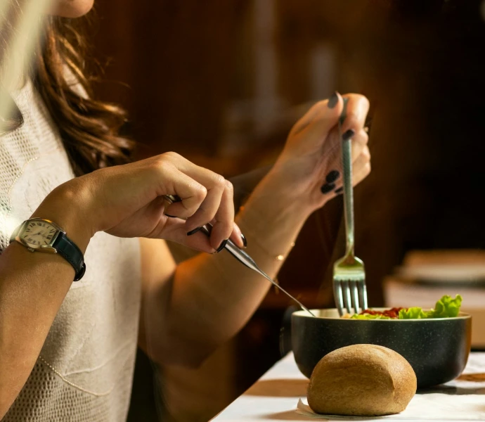person holding silver fork and knife